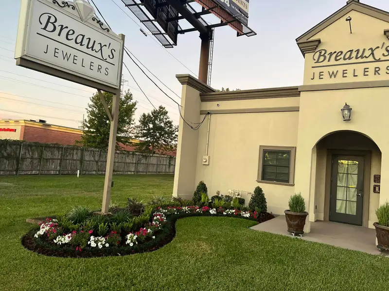 New flowers and shrubs at the entrance of Breaux's Jewelers.