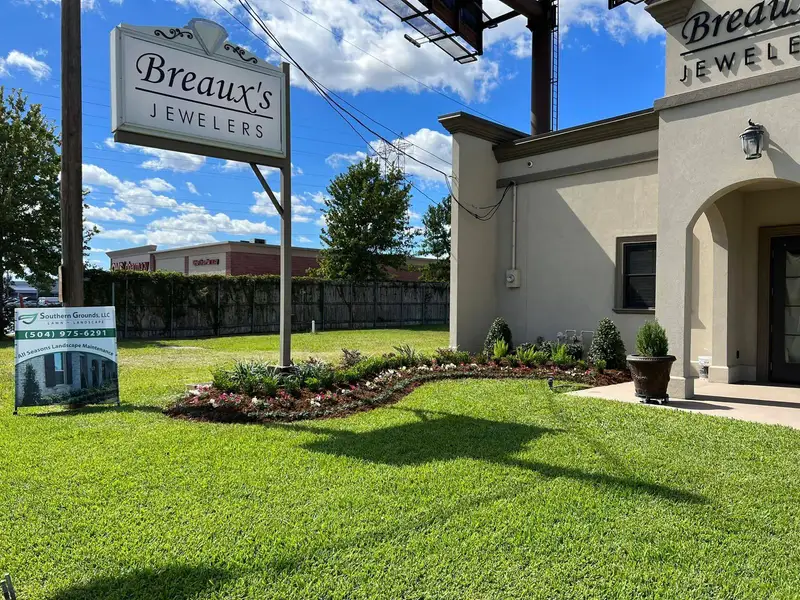 New flowers and shrubs at the entrance of Breaux's Jewelers.