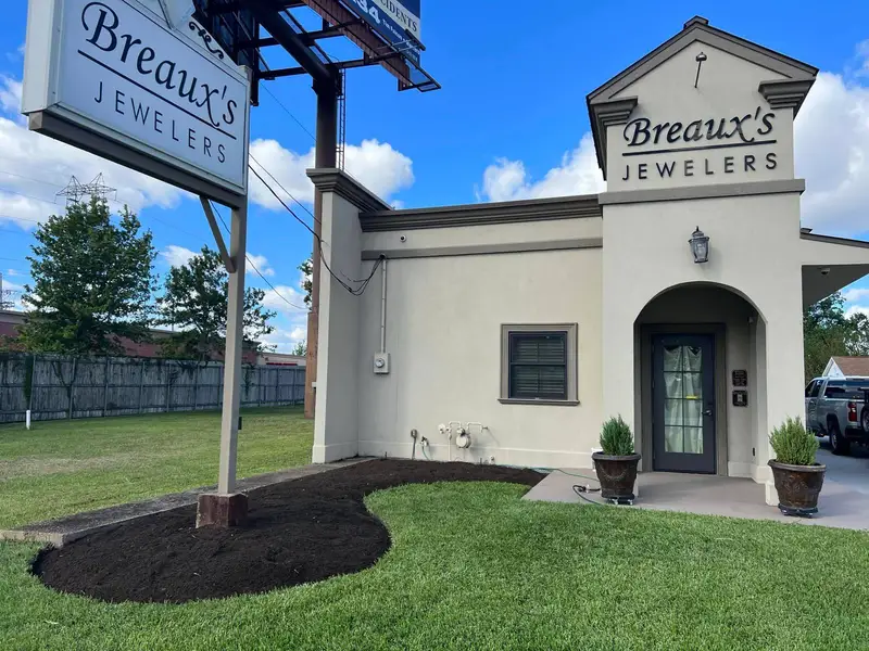 Bare soil bed at the entrance of Breaux's Jewelers, ready to plant.